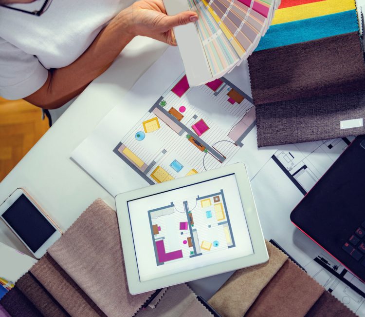 Architect interior designer looking a color samples with textile samples on their desk