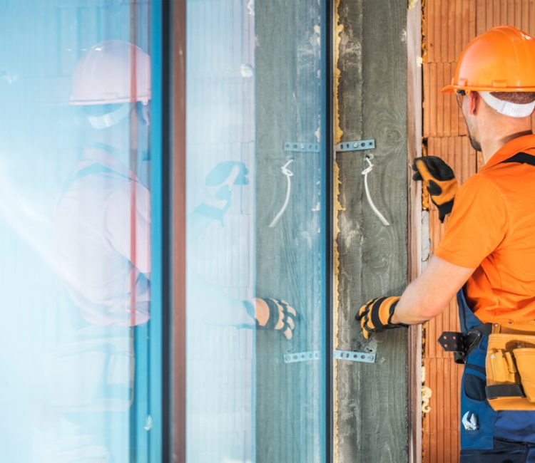 Worker installing a large window